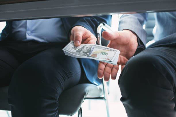 istock Determined rich businessman giving a bribe 973701686