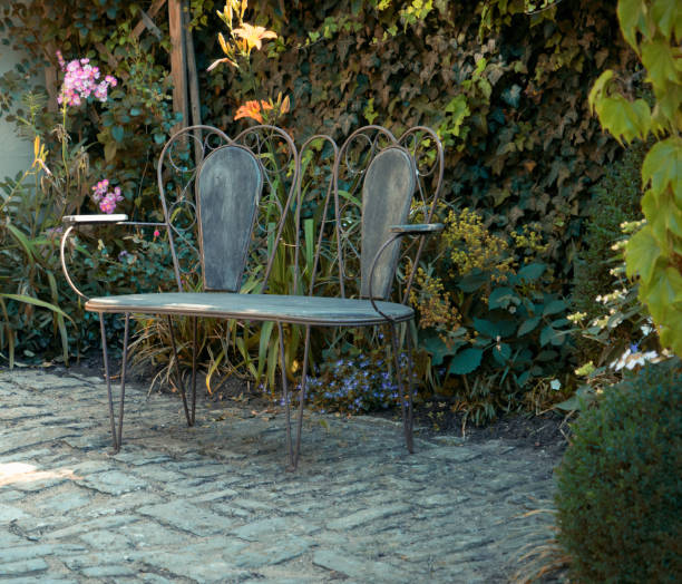 istock Creative old steel bench in the garden 973701938
