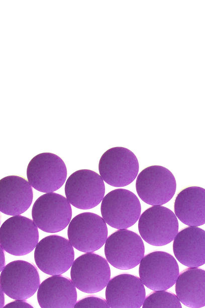 istock Violet Isolated Pills Texture. Medical Tablets Background with Place for Text. Macro Closeup. 973707890