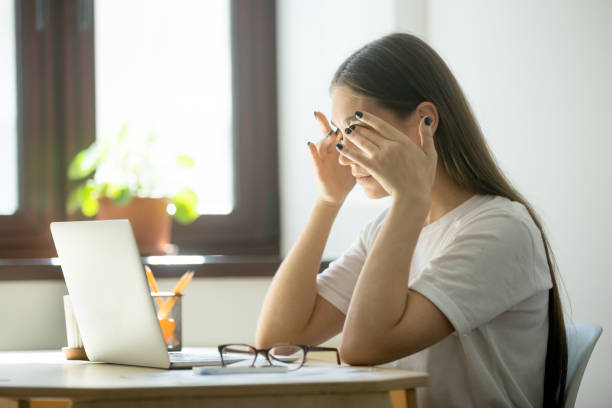 Tired female massaging eyes relieving stress