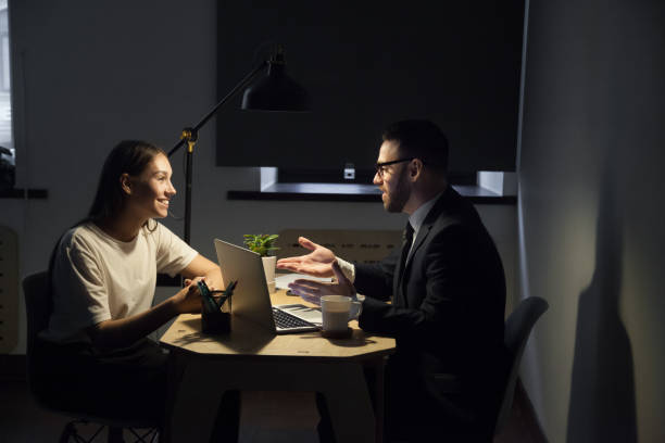 istock Colleagues working late hours in office discussing business plans 973708912