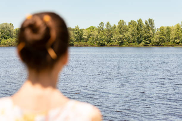 istock Woman Watching to the River 973711764