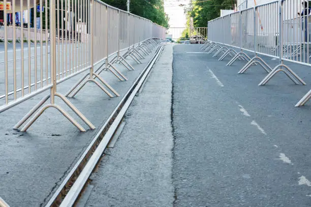 Photo of Portable metal grilles of light gray color for the obstruction of the territory and organization of the queue for the event