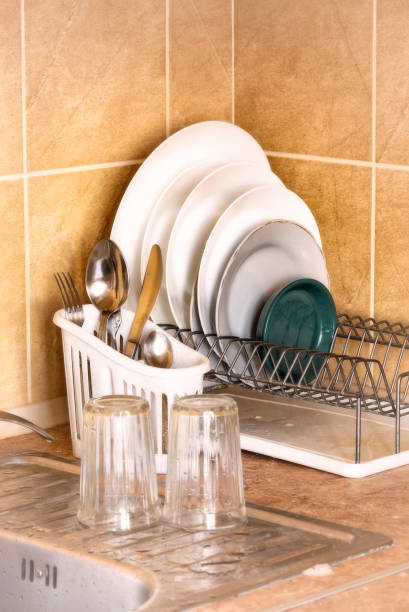 istock Plates and Cutlery Drying in the Rack 973715346