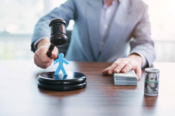 istock Mean official holding an inscribed gavel 973719122