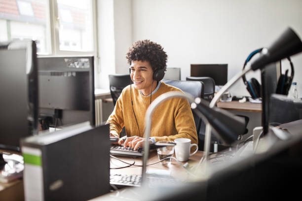 istock Smiling businessman working at his desk 973719388