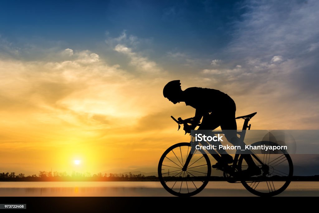 Silhouette of cyclist on the background of beautiful sunset Silhouette of cyclist on the background of beautiful sunset,Silhouette of man ride a bicycle in sunset background. Cycling Stock Photo