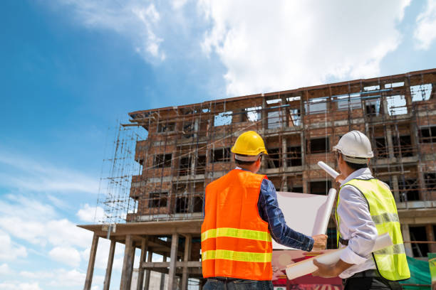 istock Businessman engineer looking blueprint in a building 973722868