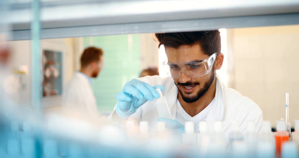 istock Attractive student of chemistry working in lab 973723094