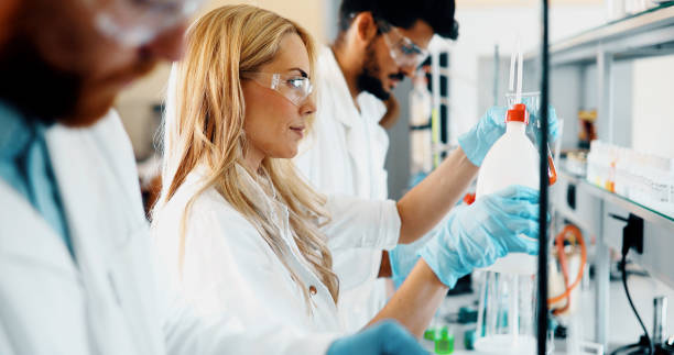 istock Young students of chemistry working in laboratory 973723212