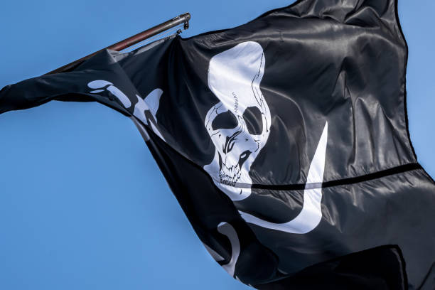 istock Pirate flag in the wind 973725808