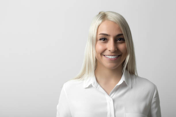 istock Smiling woman over gray background 973726938