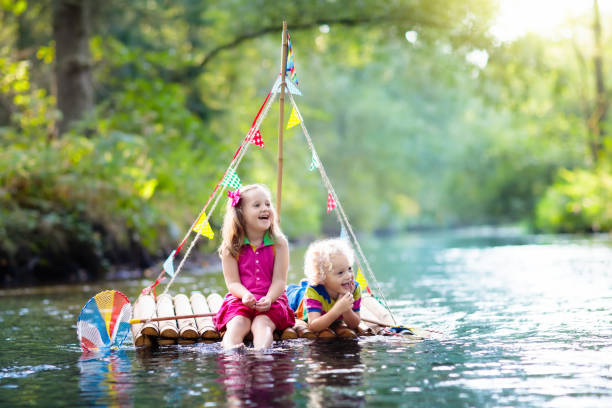 istock Kids on wooden raft 973729480
