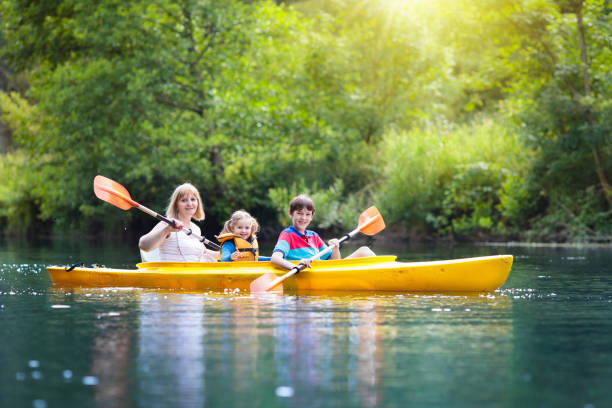 istock Child on kayak. Kids on canoe. Summer camping. 973731202