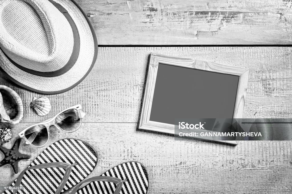 black and white. beach, sand, background, summer vacation, tablet, travel, cope space black and white. Summer vacation composition. Sandals, sunglasses, hat, tablet and smartphone. cope space top view Activity Stock Photo