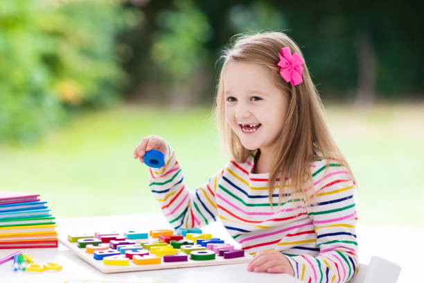 istock Child doing homework for school. Kids learn and paint. 973736442