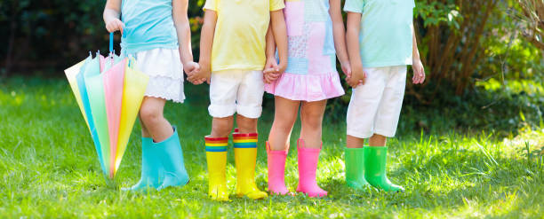 istock Kids in rain boots. Rubber boots for children. 973736540