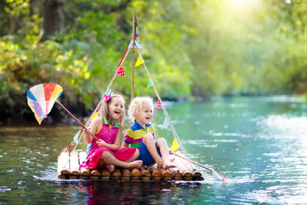 istock Kids on wooden raft 973737418