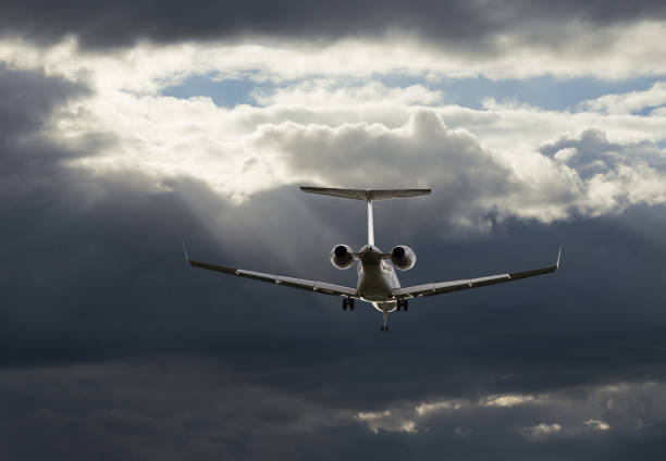 istock Airplane flying in sky with clouds at sunset time 973739732