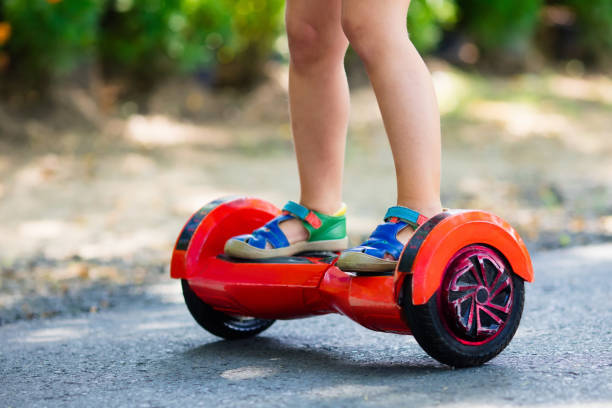 istock Child on hover board. Kids ride scooter. 973745552