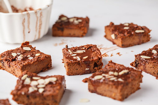 Vegan sweet potato brownie on white table. Healthy vegan food concept.