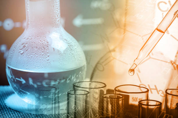 istock Dropping chemical liquid to test tube with lab glassware background, science laboratory research and development concept 973751156