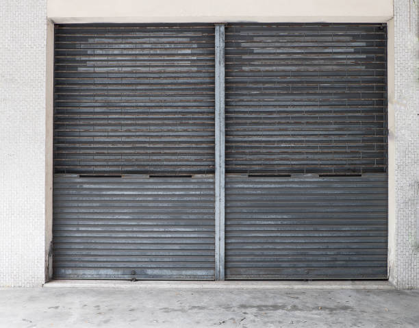 istock Rolled steel door with rust on the door.Door frame is white tile. 973753422