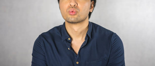 istock Kiss gesture by man on grey background 973754970