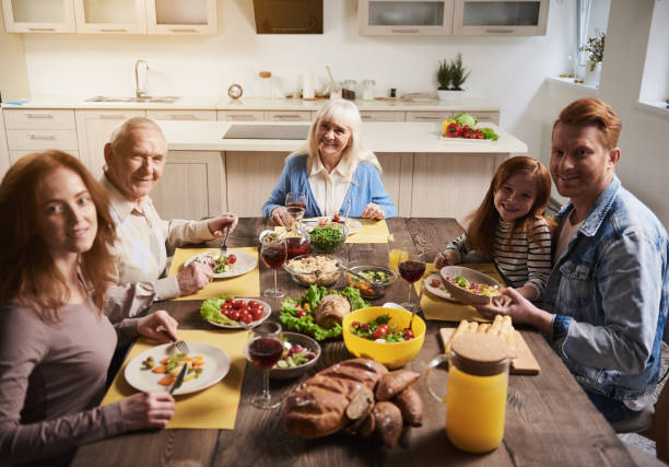 istock Joyful family gathering at one table 973757154