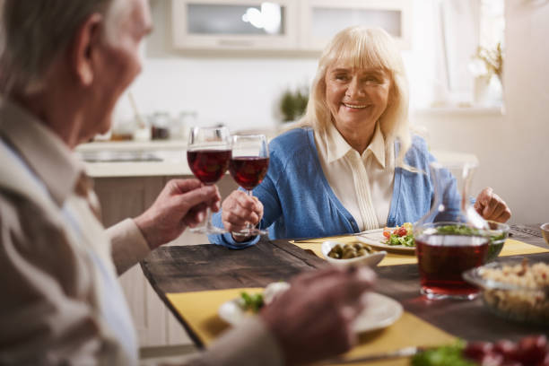 istock Mature family relaxing at dinner table 973757666