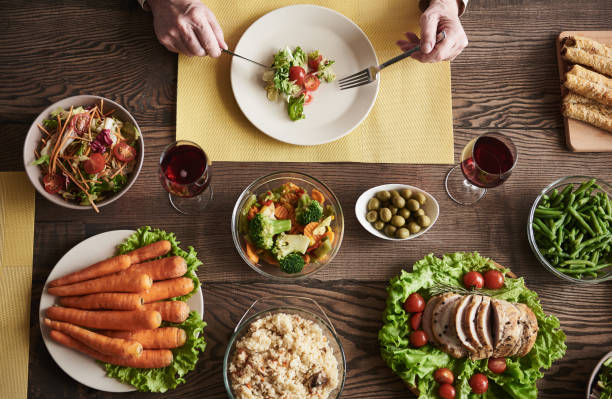 istock Mature man eating at wooden table 973758016