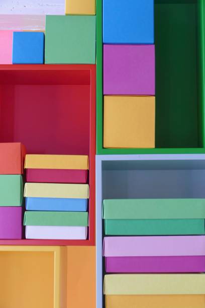 multi colored boxes in the shelf - shelf bookshelf empty box imagens e fotografias de stock