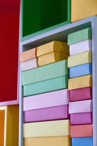 multi colored boxes in the shelf - shelf bookshelf empty box imagens e fotografias de stock