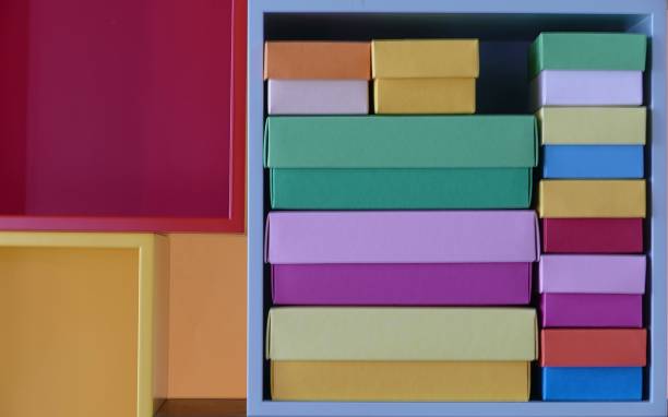 multi colored boxes in the shelf - shelf bookshelf empty box imagens e fotografias de stock