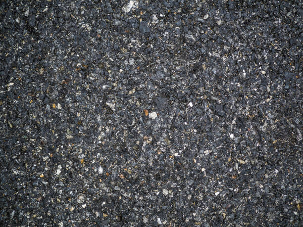 istock Asphalt texture - road surface background. stone asphalt texture background black granite gravel 973762012