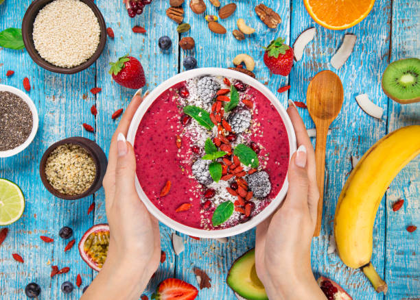 istock Smoothie bowl with fresh berries, nuts, seeds, fruit and vegetables 973762134