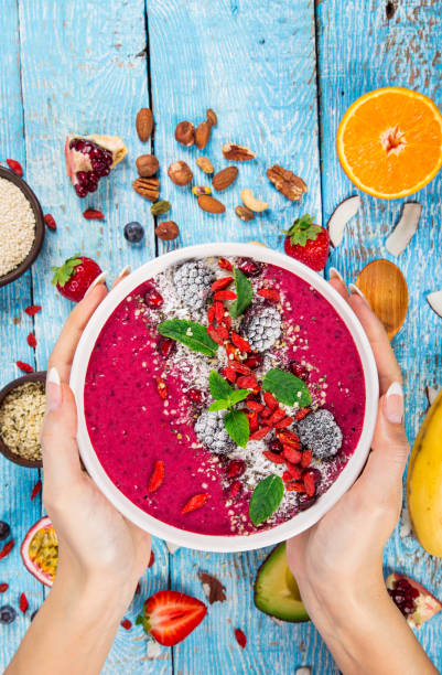 istock Smoothie bowl with fresh berries, nuts, seeds, fruit and vegetables 973762528