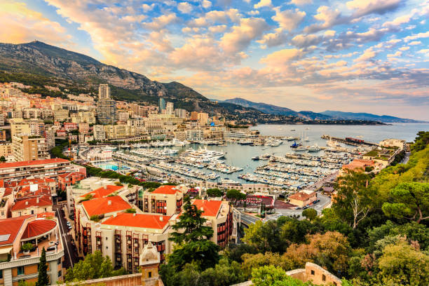 Monte Carlo marine with yachts and sail boats and town view at sunset. stock photo