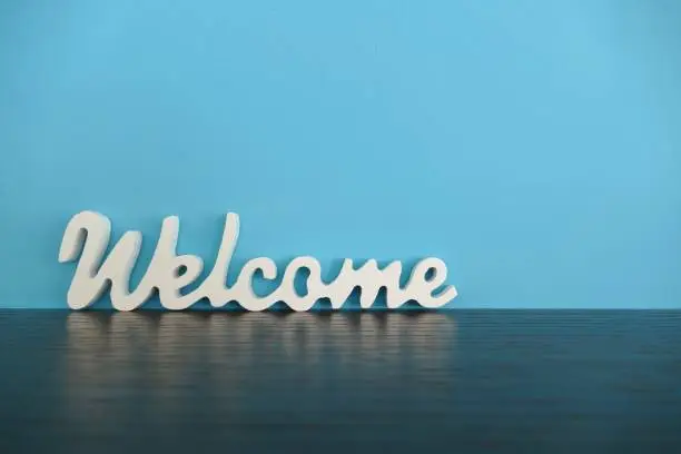 Word welcome on blue background