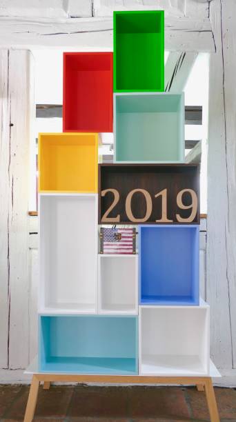 year 2019 in wooden numbers in colorful empty boxes - shelf bookshelf empty box imagens e fotografias de stock