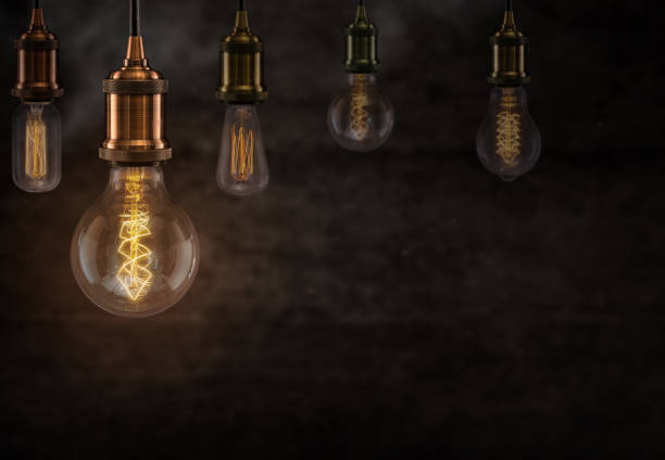 istock Vintage light bulbs on dark background 973766276