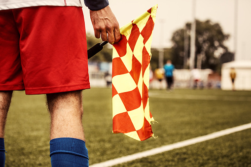 A close up of an unidentified linesman during a football match