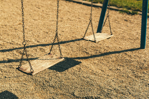 istock Pair of empty wooden swings 973767730