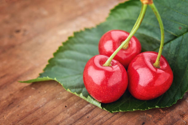 istock Cherry - Heap of berries on wood. 973768164