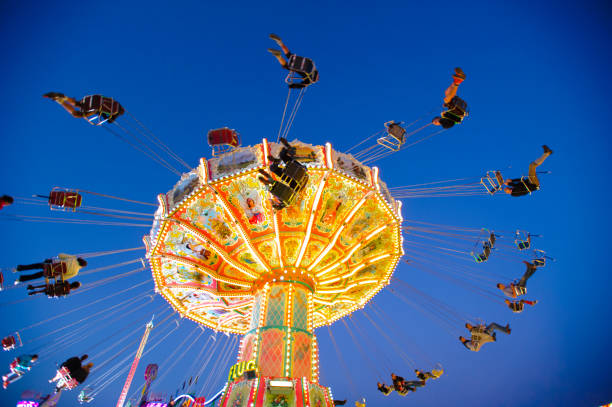 carousel with flying people at oktoberfest in munich, germany - amusement park oktoberfest munich chain swing ride imagens e fotografias de stock