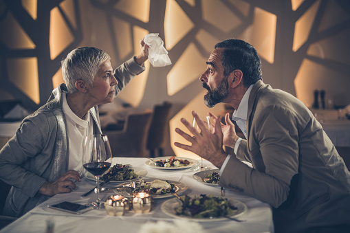 Young blond waitress getting an order from a group of friends in an American style restaurant