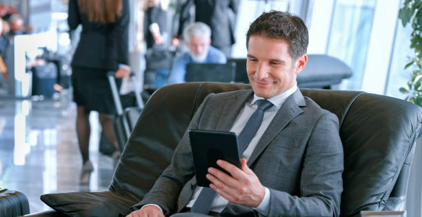 istock Businessman using digital tablet at airport 973783130