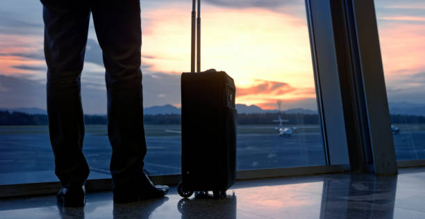 istock Businessman standing at airport 973783156