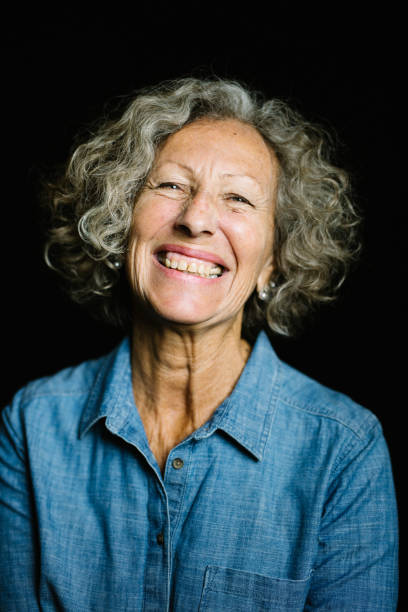istock Senior Woman Smiling On Black Background 973786264