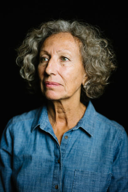 istock Senior Senior Woman On Black Background 973786276